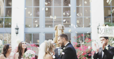 Couple staning at the alter with flowers