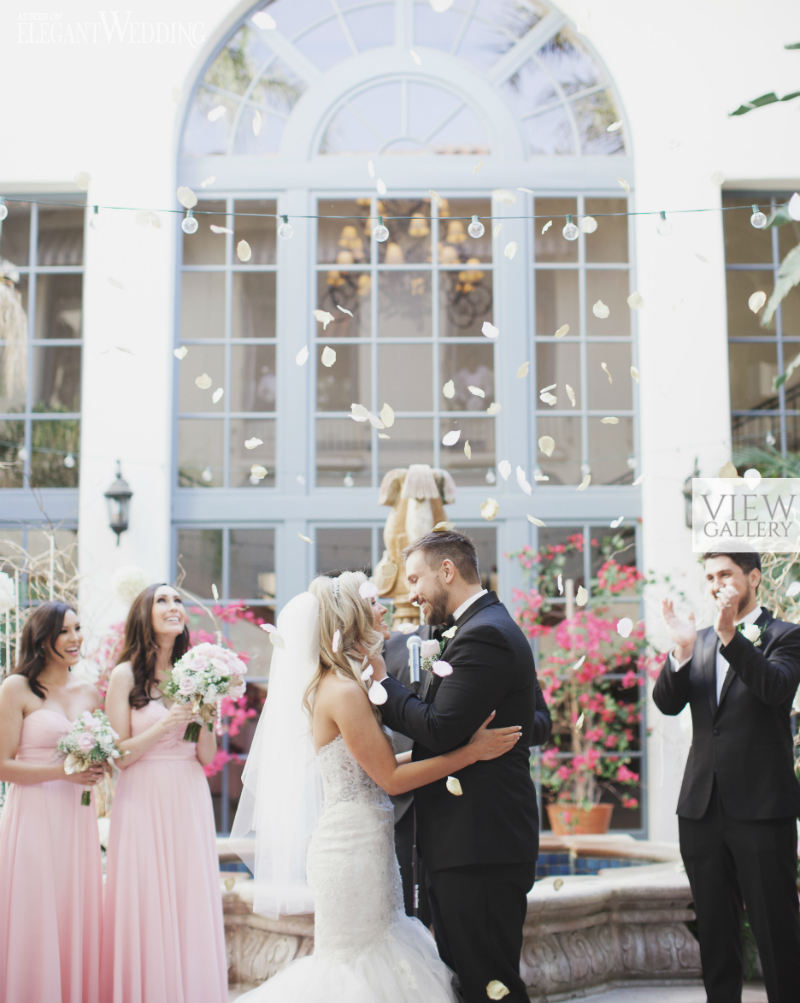 Couple staning at the alter with flowers