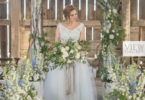 wedding ceremony with bride holding a rustic blue bouquet