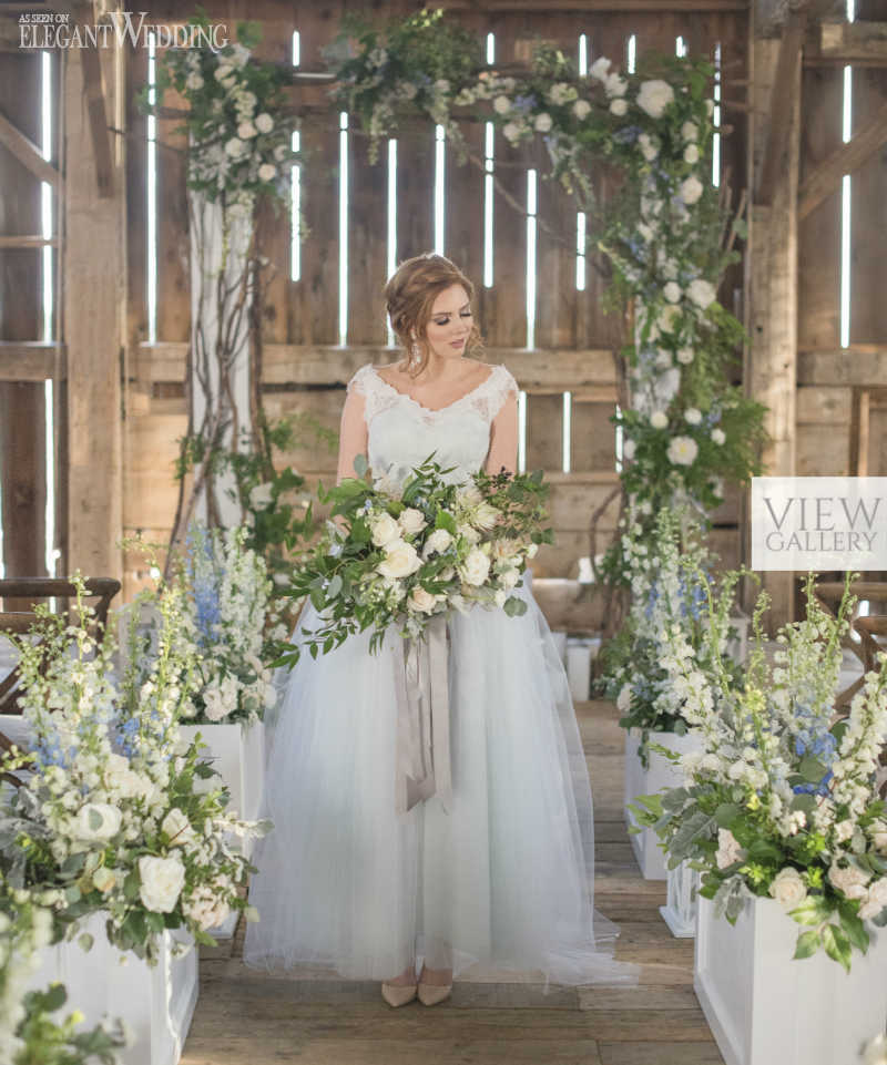 wedding ceremony with bride holding a rustic blue bouquet