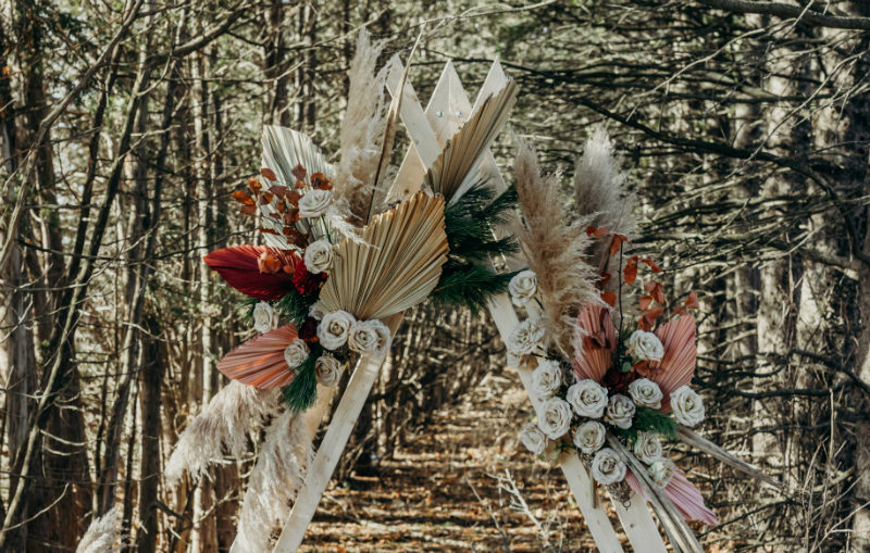 rustic wedding ceremony with a boho arch