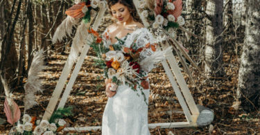 rustic wedding ceremony with a boho arch