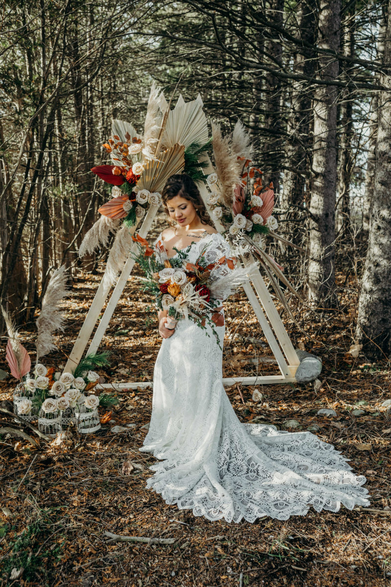 rustic wedding ceremony with a boho arch