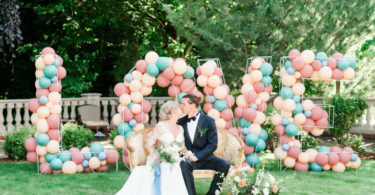 bride and groom in a garden wedding with Love Balloons