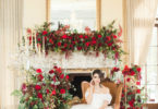 bride surrounded by red roses