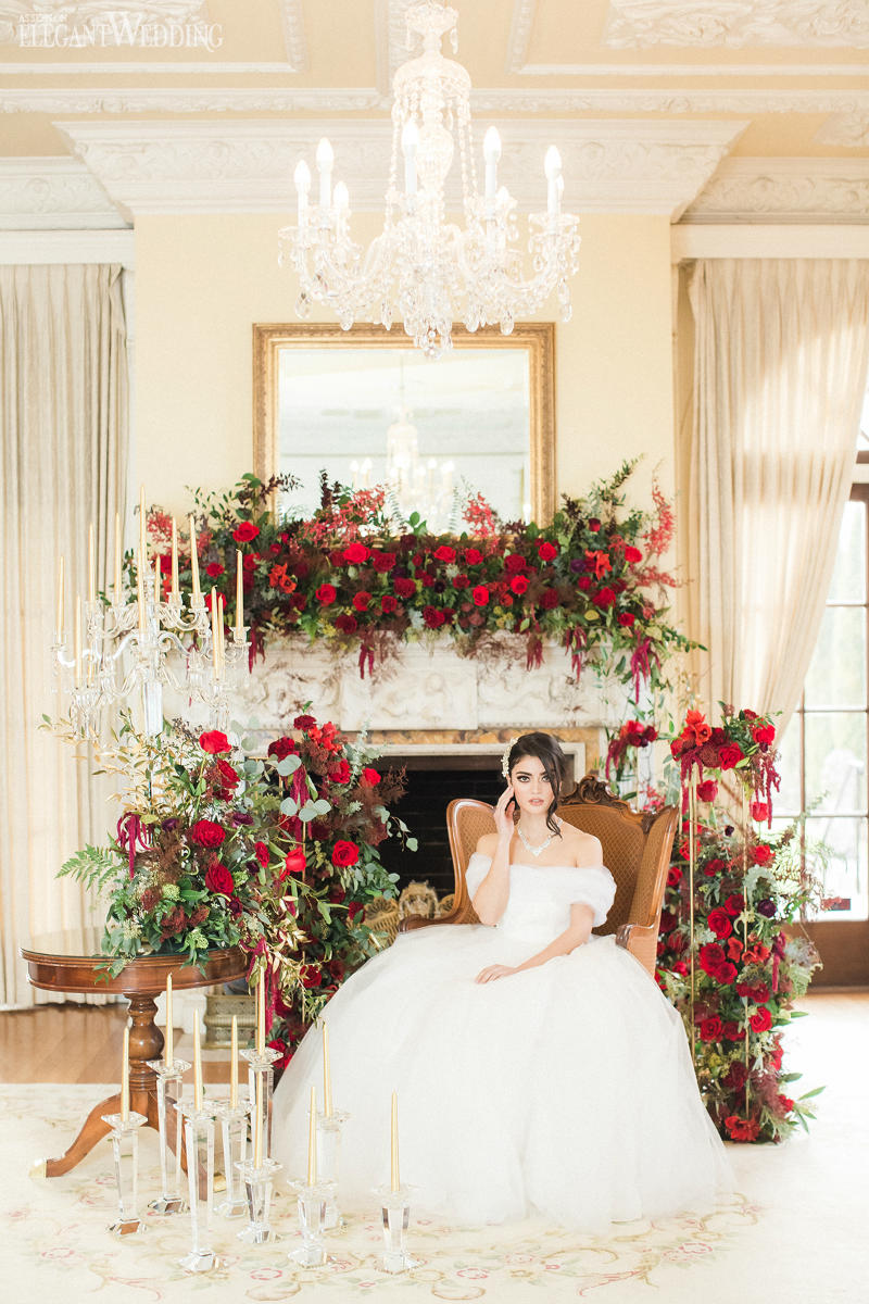 bride surrounded by red roses