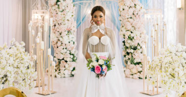 wedding dress with pink wedding ceremony flowers