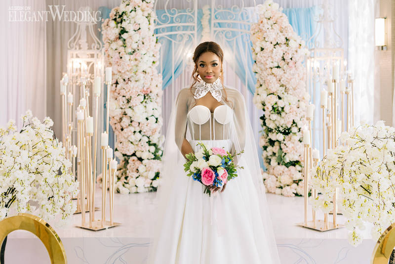 wedding dress with pink wedding ceremony flowers