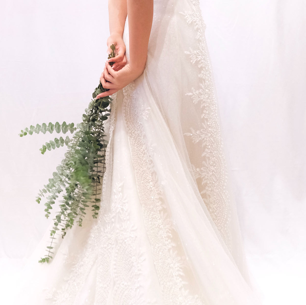 bride holding greenery