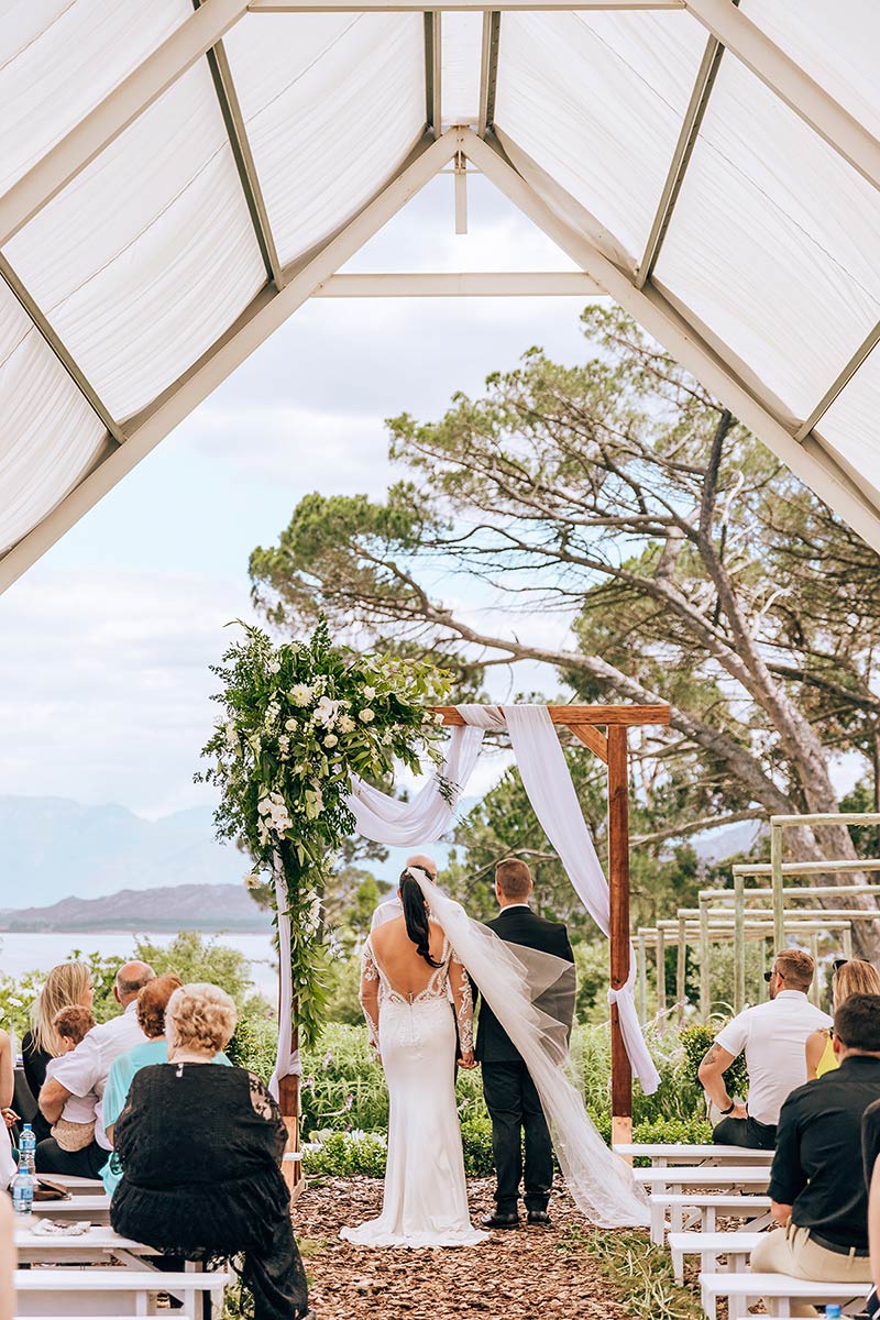 wedding ceremony with a wooden arch