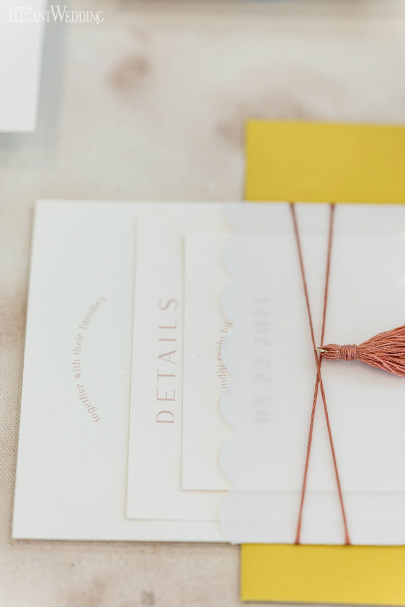 white invitation with yellow envelope