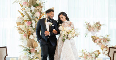 bride and groom in a gold and white ceremony theme