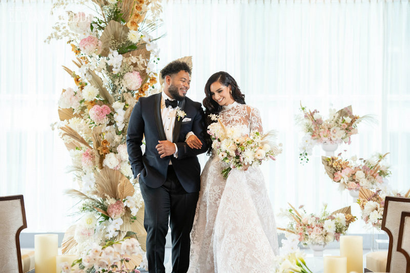 bride and groom in a gold and white ceremony theme