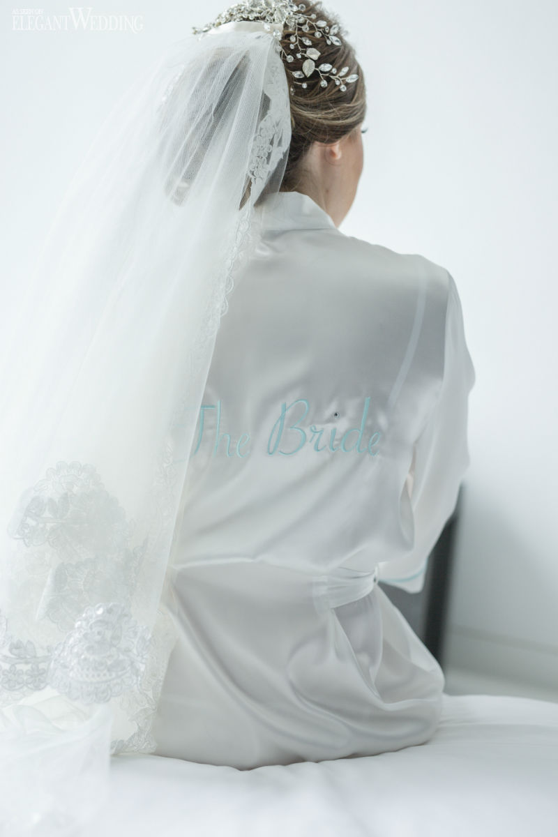 bride in a white robe getting ready