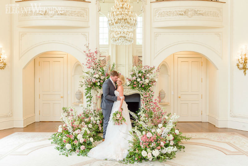 bride and groom in front of a fireplace