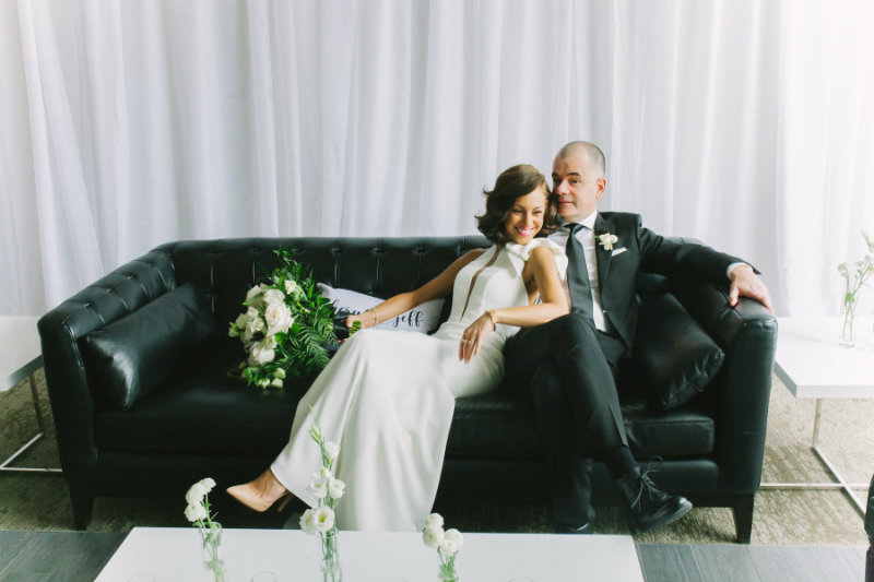 couple sitting on a black couch