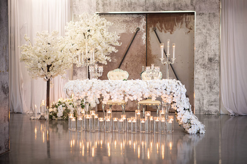 white glass table with flower cascading flowers