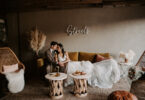 bride and groom sitting on a sofa at a wedding