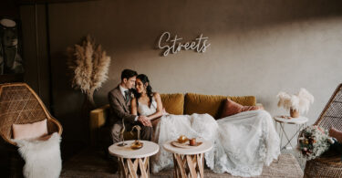 bride and groom sitting on a sofa at a wedding