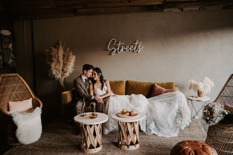 bride and groom sitting on a sofa at a wedding