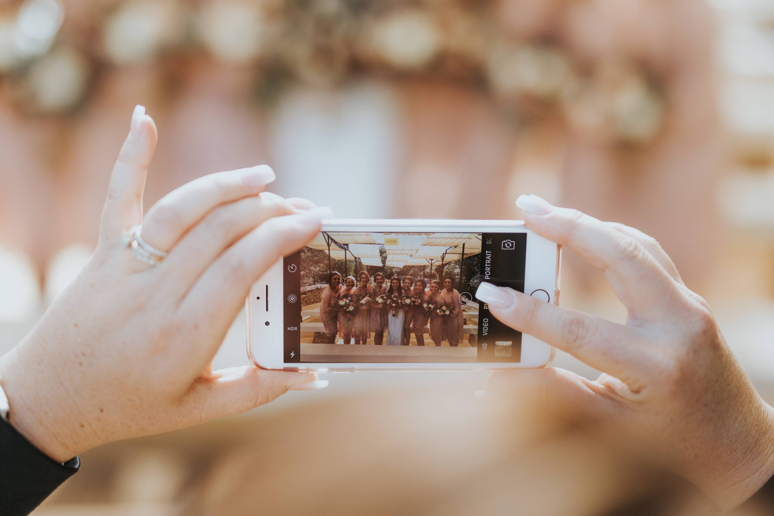 friends taking wedding photos