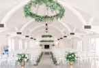 green and white wedding ceremony with hanging floral chandelier