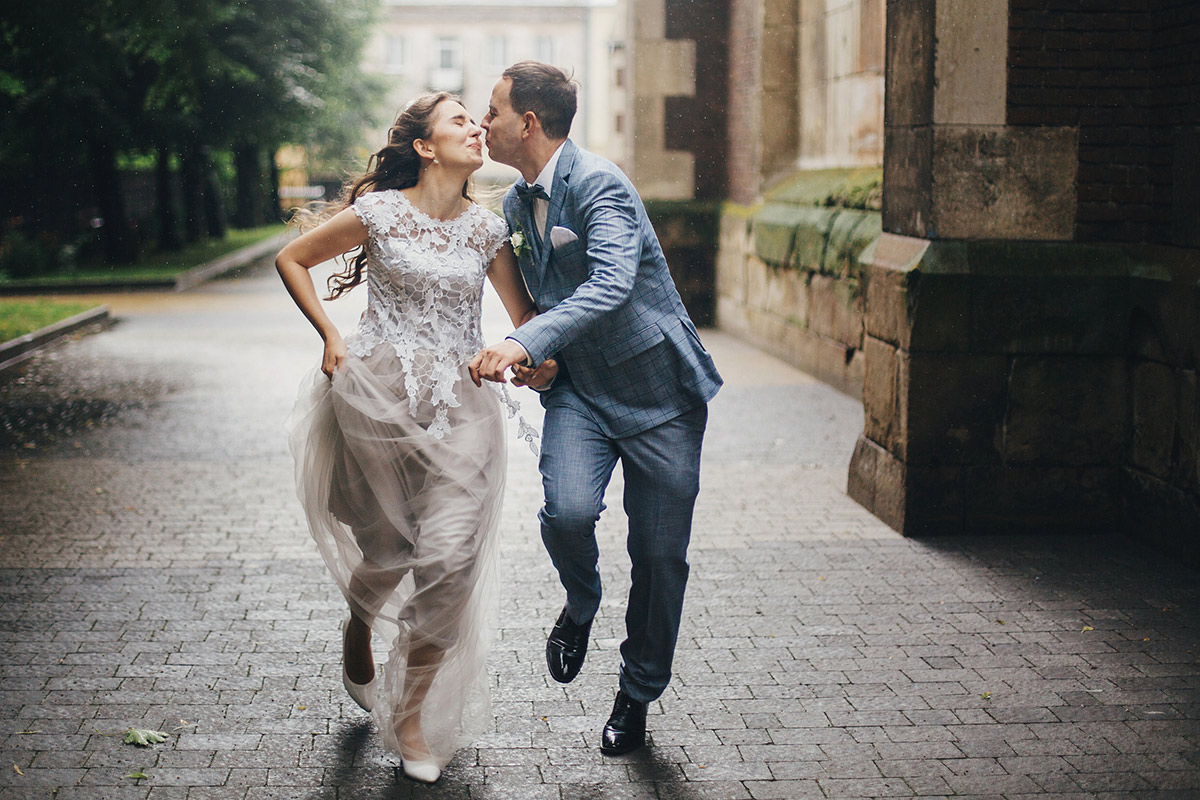 wedding couple running in the street