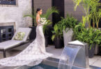 bride in a lace dress with a green and white bridal bouquet