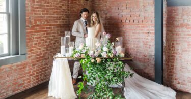 bride and groom with a white wedding cake