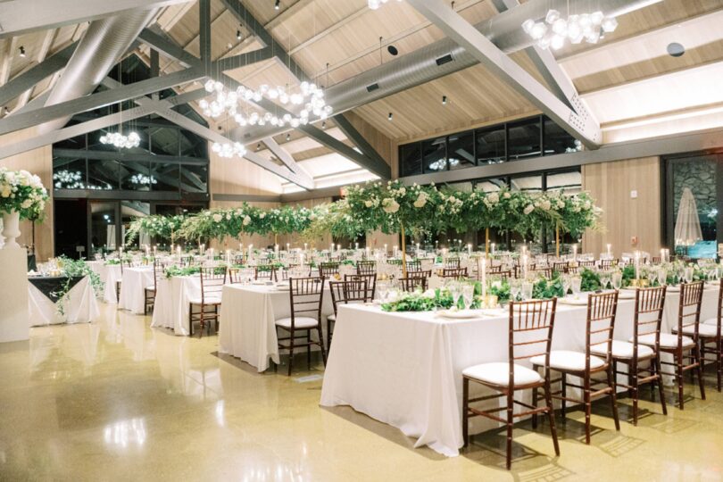 tall green and white floral arrangements for a wedding